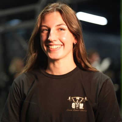 Young woman smiling in a black t-shirt.