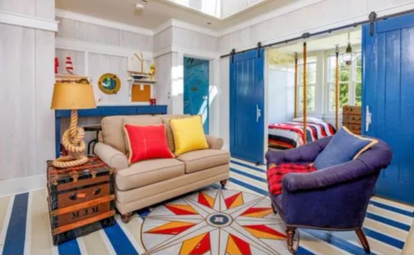 Cozy living room with nautical decor and vibrant colors.