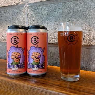 Cups and cans of Purple Pinky Pale Ale.