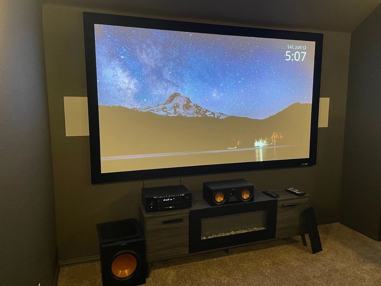 Modern media room with large screen TV and surround sound system