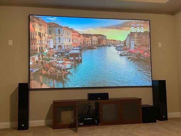 Home media room featuring big screen display and premium sound system