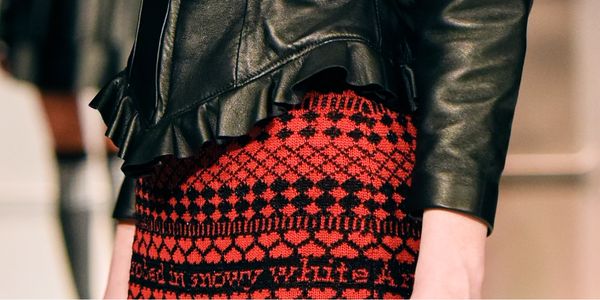 Detail of a leather jacket and knit skirt.