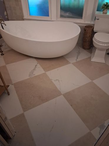 Bathroom with a freestanding tub and checkered tile floor.
