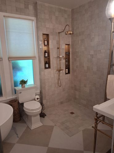 Modern bathroom with walk-in shower and toilet.