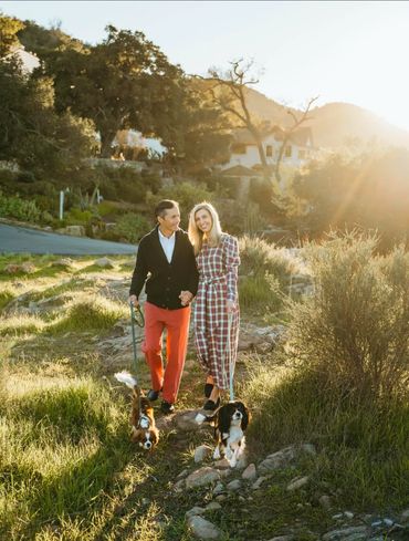 Family walking on trail with two Cavalier King Charles Spaniels