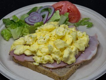 Scramble eggs and ham on rye 