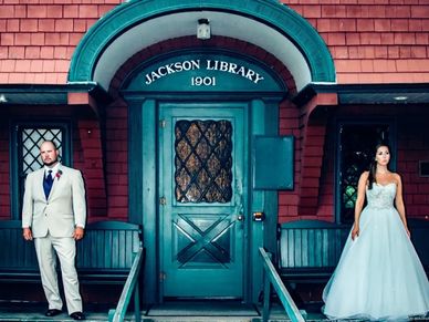 Bride and groom stand on the pourch of the Jackson Library. Wes Anderson Style wedding photo