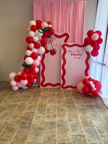 Cherry-themed balloon decoration with signage.