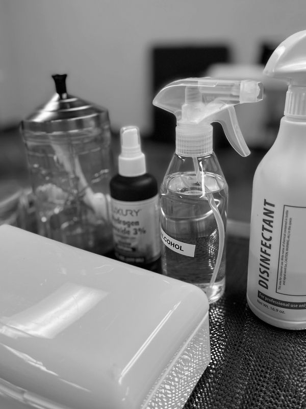 Various disinfectant and cleaning bottles on a table.