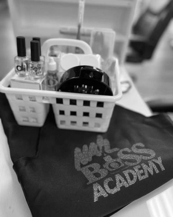 A nail care kit and a cloth with 'Nail Boss Academy' printed.