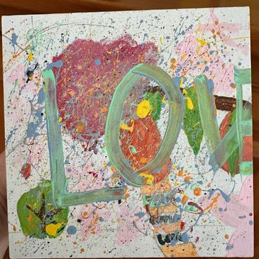Abstract painting with the word 'LOVE' in large green letters and colorful splatters.