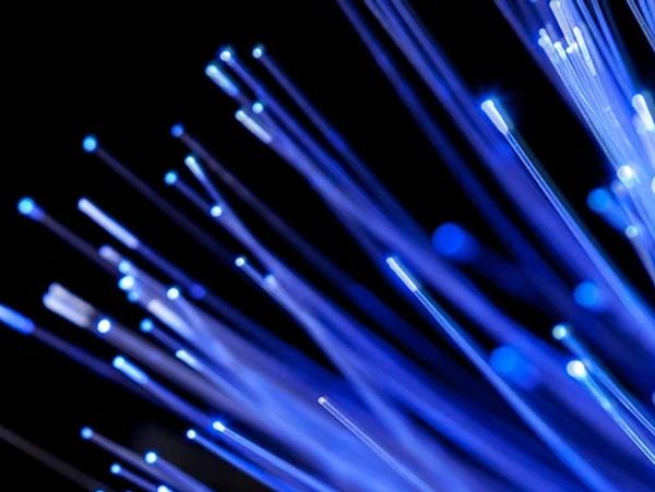 Blue fiber optic light strands glowing in the dark.