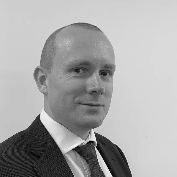 Professional man in suit and tie posing for a portrait.