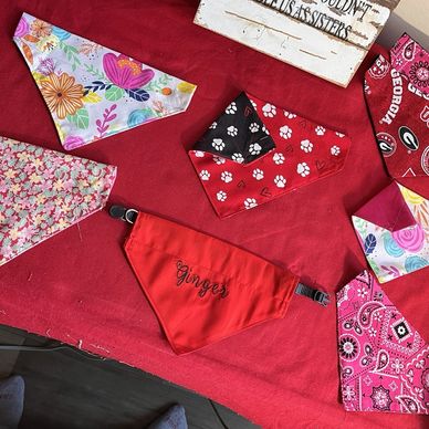 Colorful dog bandanas with various patterns and a red one labeled 'Gingers'.