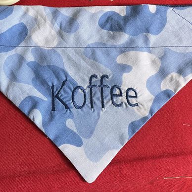 Blue camouflage fabric with the word 'Koffee' embroidered.