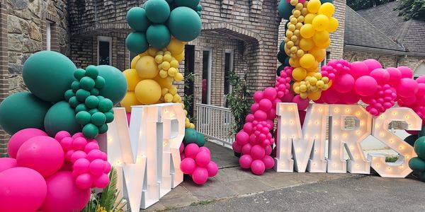 Front entrance to silver stone castle wedding venue decorated with balloons and marquee letters