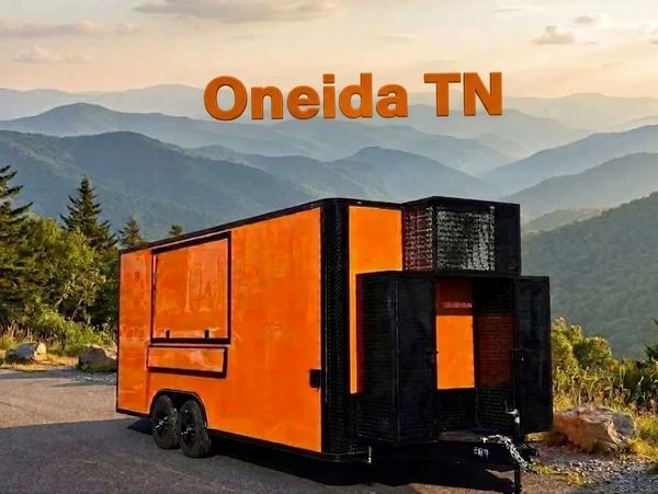 Bright orange food trailer parked with mountain view in Oneida, TN.