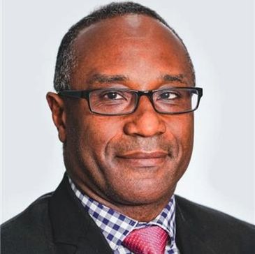 Professional man wearing glasses, suit, and a red tie.