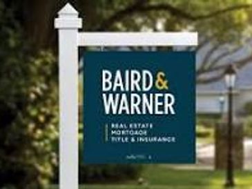Real estate and mortgage sign for Baird &amp; Warner.