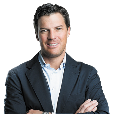 Confident man in a dark suit with arms crossed.
