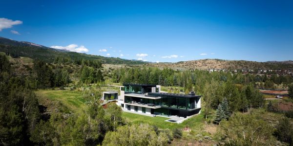 Modern house nestled in a lush green valley.
