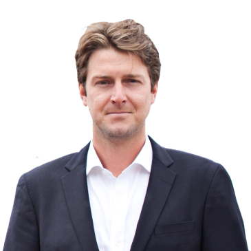 Man wearing a black blazer and white shirt.