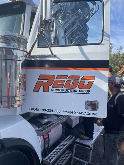 picture of truck door with Rego construction logo on it