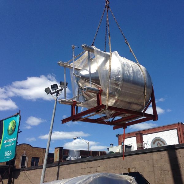 heavy equipment being hoisted on to roof