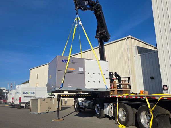 commercial ac unit being lifted