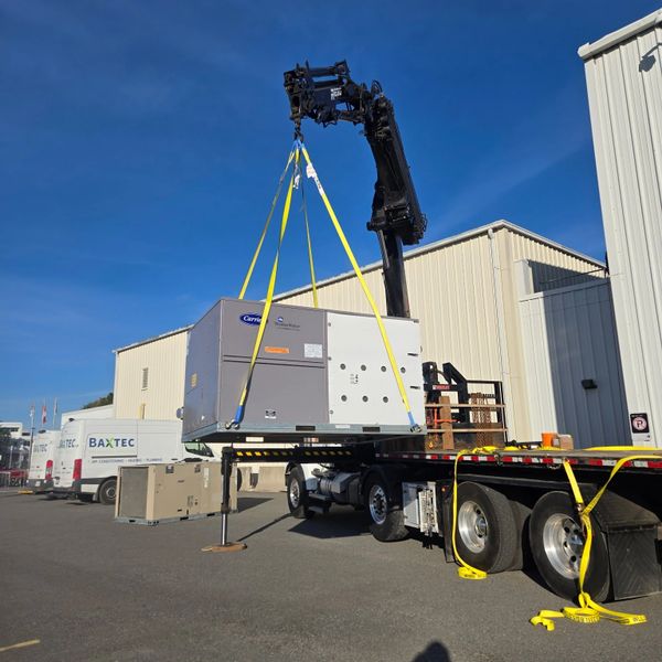 crane lifting commercial hvac unit