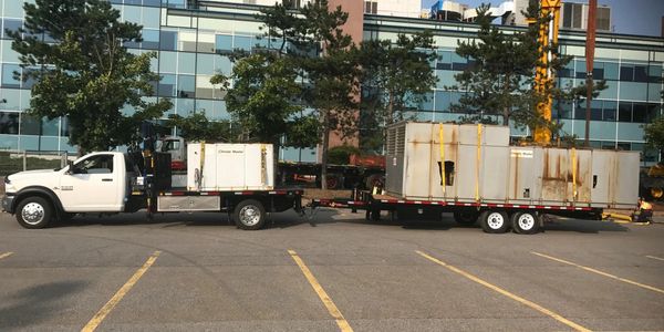 truck transporting old commercial hvac unit