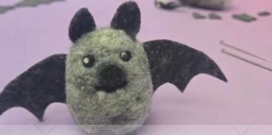 Cute felt bat with big eyes and wings.
