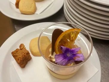 Fresh and healthy drink with lemon, served with bread and cheese on a plate.