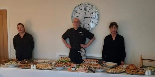 5 Star Film Catering team in Liverpool ready to serve food at a catered event.