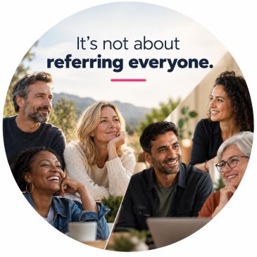 Group of diverse people smiling together around a laptop.