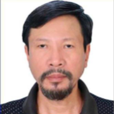Portrait of a man with short black hair and a goatee beard.