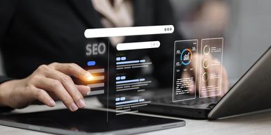Person interacting with futuristic SEO data interfaces on a digital tablet.