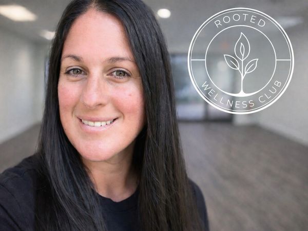 Smiling woman with long dark hair in a wellness center.
