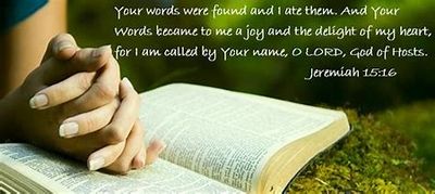 Hands clasped in prayer over an open Bible with a Jeremiah 15:16 verse.