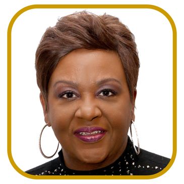 Portrait of a woman with short hair and hoop earrings.