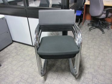Modern office chair with metal frame and cushioned seat.