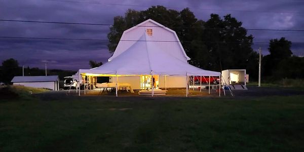 nighttime tent in field with lights