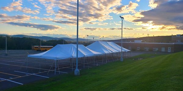 school tent set up with sunset