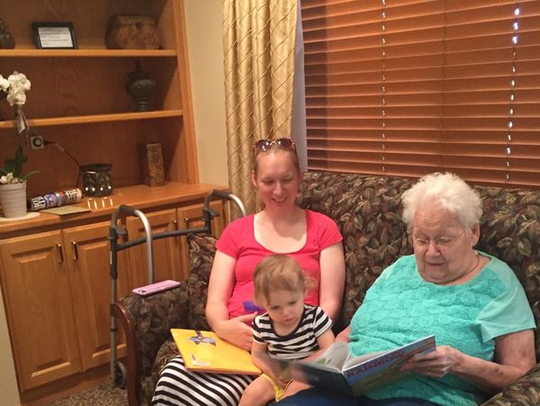 Grandmother reading to grandchild of founder of Day Global Group LLC.