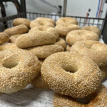 sesame bagels on baking rack