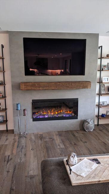 Recessed TV installed above fireplace in Family Room