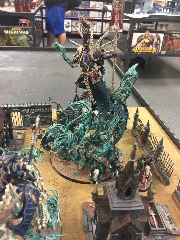 Detailed Warhammer fantasy miniatures in a battle diorama.