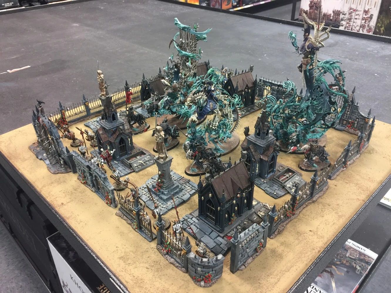 Intricately painted fantasy miniatures set in a spooky cemetery diorama.