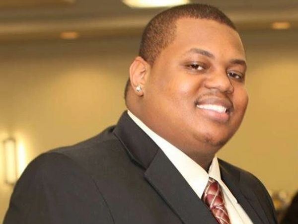 Smiling man in formal attire.