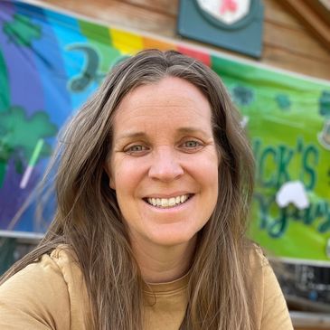 childcare provider smiling at outdoor preschool near Edmonds, WA